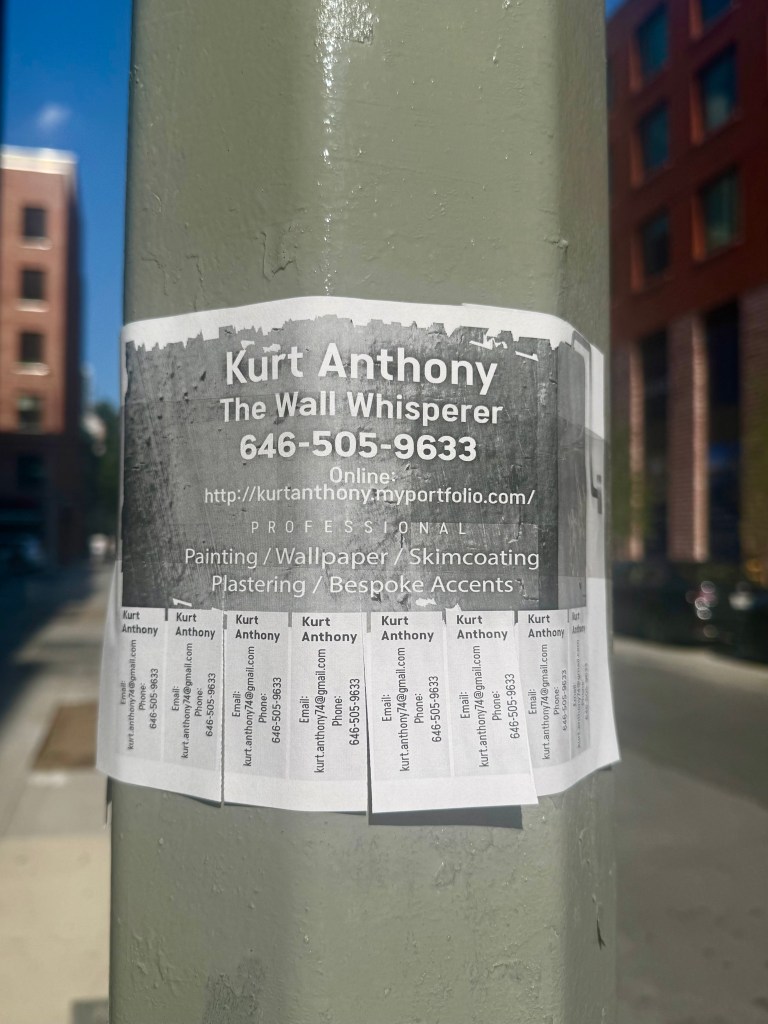 Promotional flyer for Kurt Anthony, 'The Wall Whisperer', displaying contact information and services offered such as painting, wallpaper, skimcoating, plastering, and bespoke accents. The flyer is attached to a utility pole.